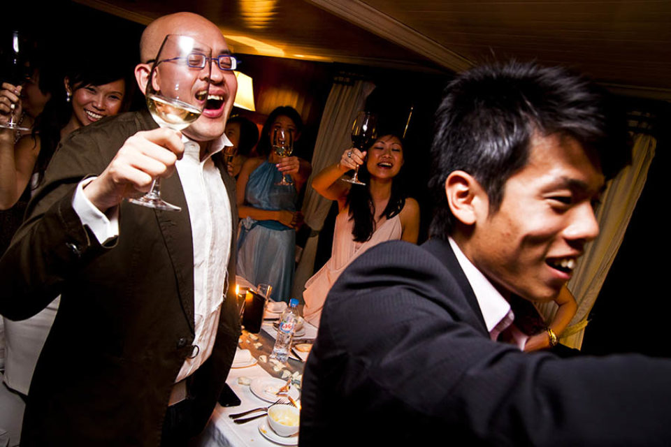 Guests toasting couple during wedding reception