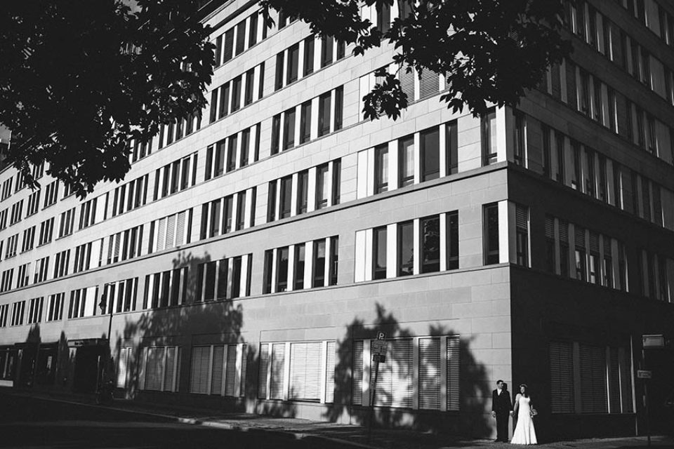 Black and white city portrait of bride and groom in Berlin