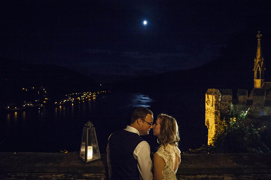portrait of newlyweds kissing under moon