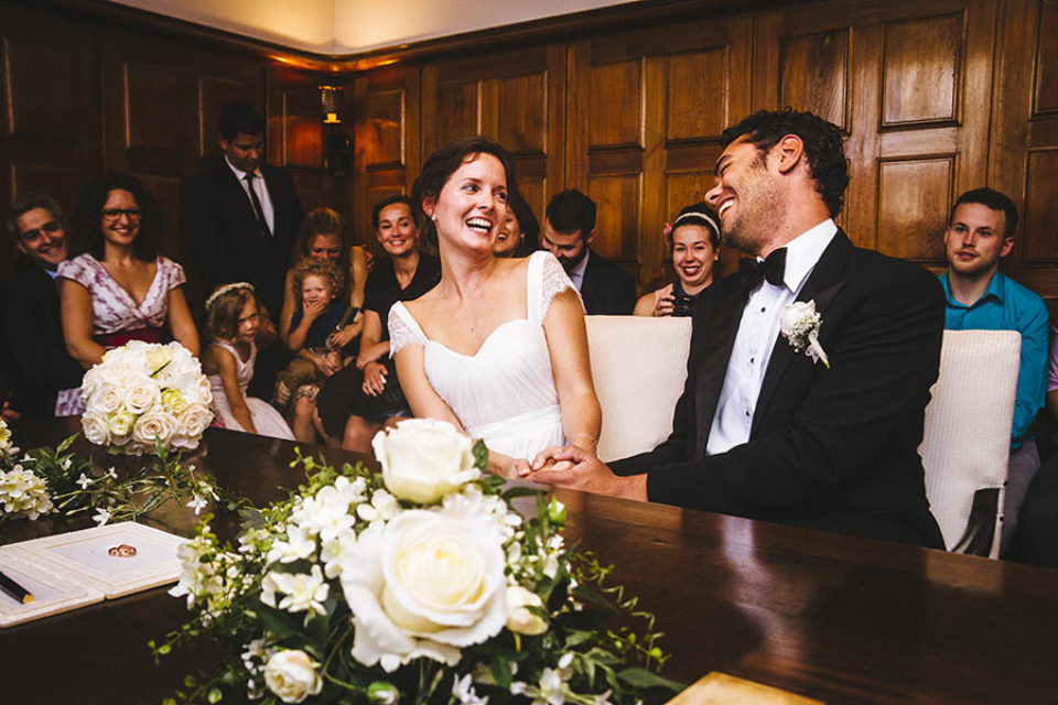 Bride and groom laugh during ceremony