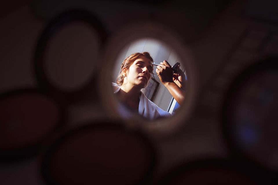 Bride reflected in makeup mirror