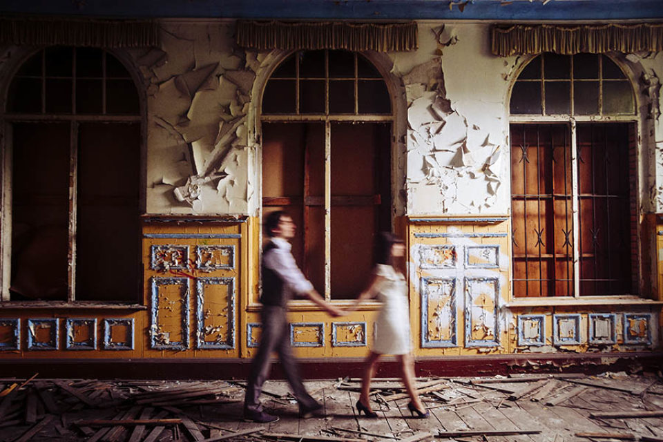 Couple walking through abandoned building