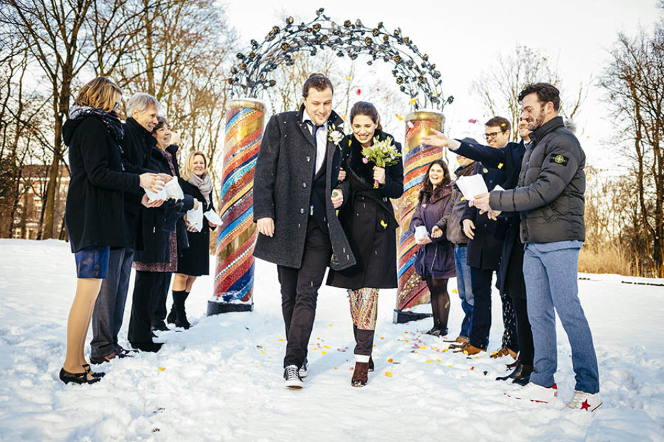 Confetti thrown at a snowy winter wedding