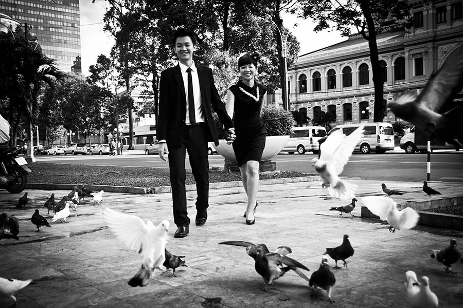 Couple walking through flying birds