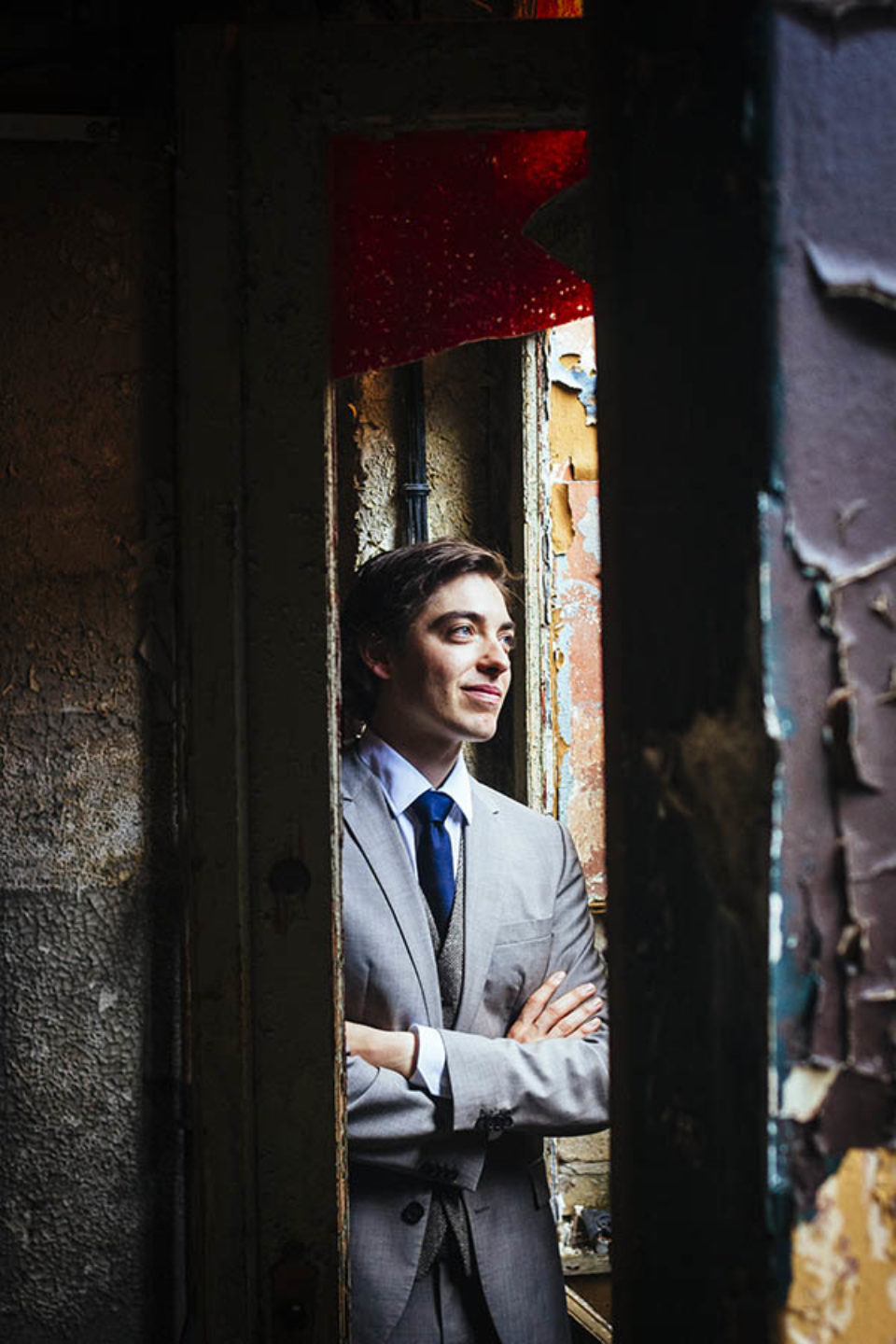 Groom in doorway of abandoned building