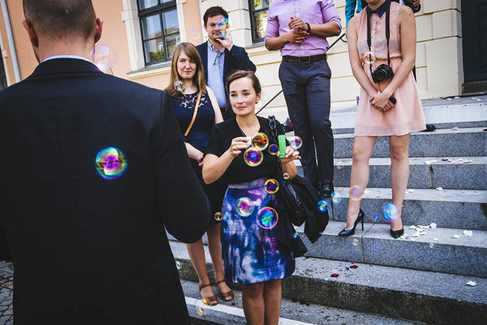 Wedding guests blow soap bubbles