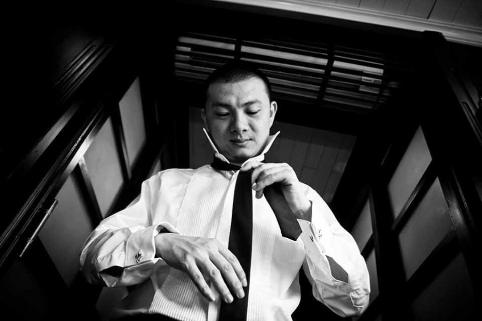 Groom tying his tie