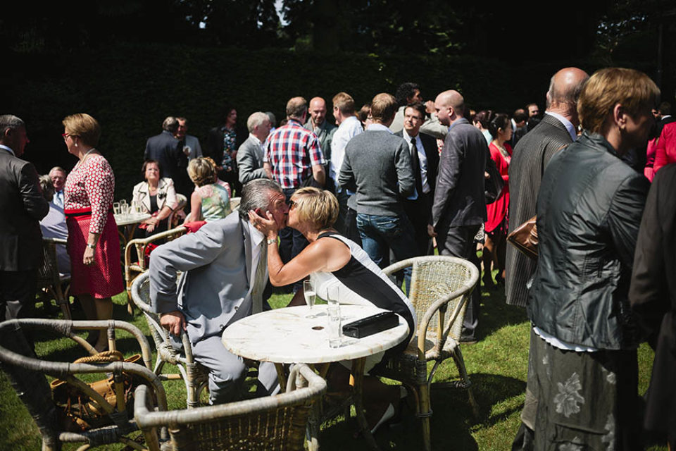 A couple kisses during a wedding reception