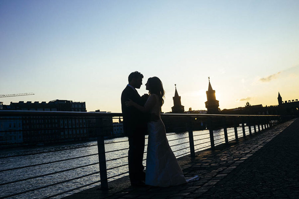 Couple silhouetted by riverside