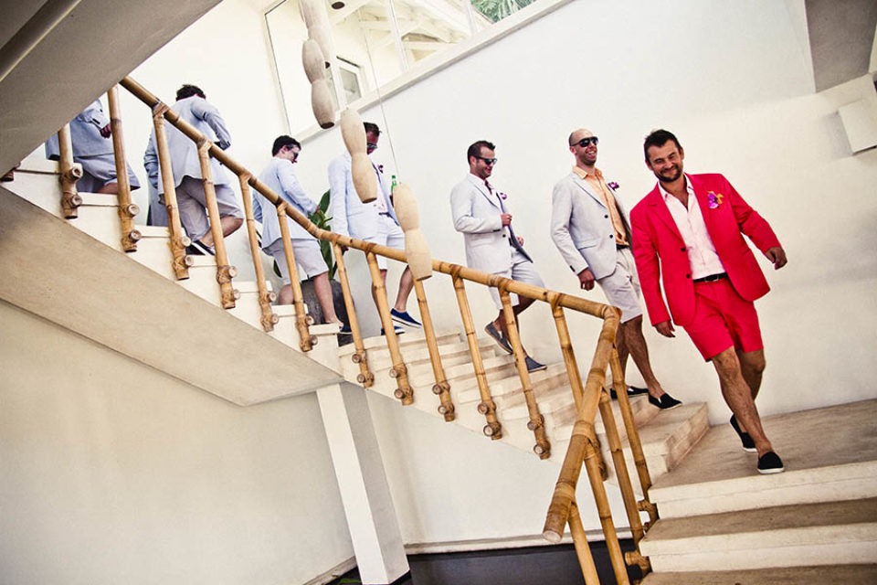 Groom and best men descending staircase