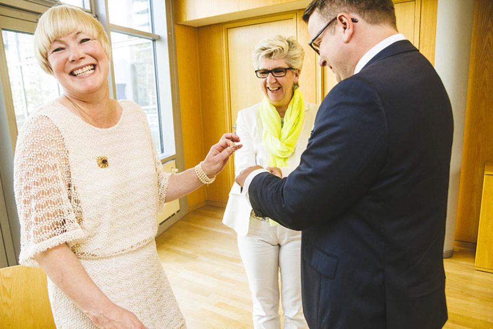 Bride laughs during wedding ring exchange