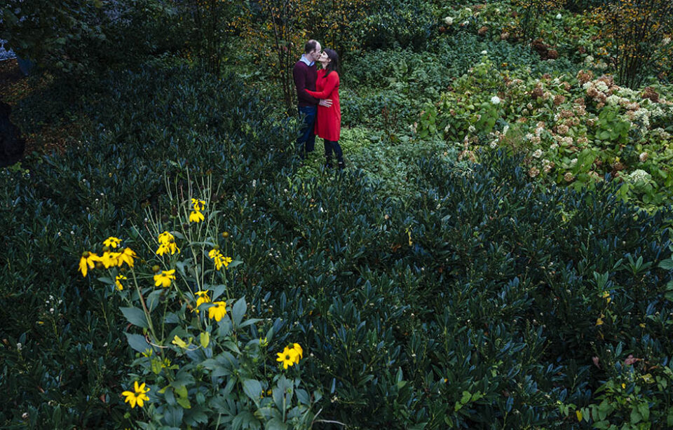 Couple kiss in flowerbed