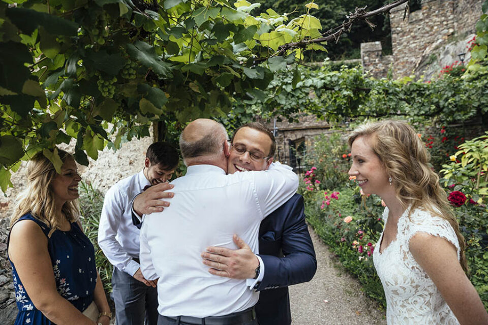 Groom greeting wedding guests