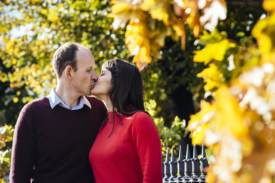 Couple kissing in autumn leaves