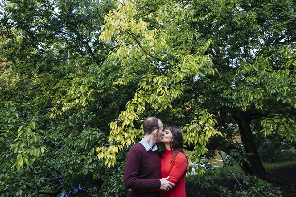 Couple kissing by tree