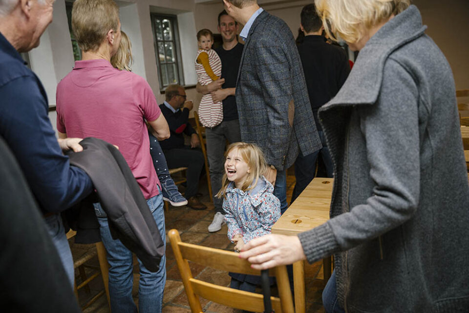 Girl laughing with family