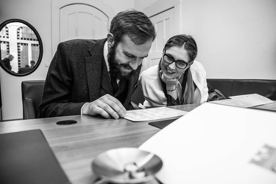 Bride and groom inspect marriage license