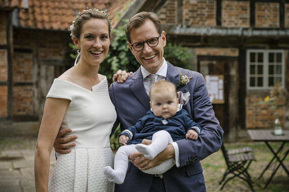 Bride and groom with their child