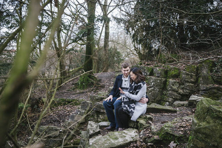 Woman admiring her engagement ring in woods