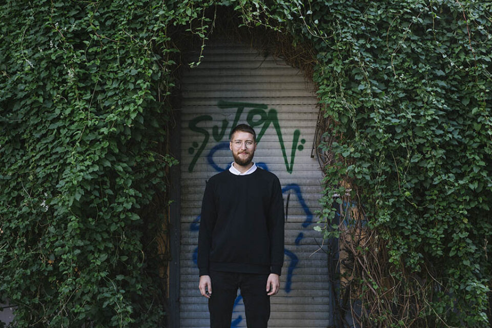 Man green leafy doorway