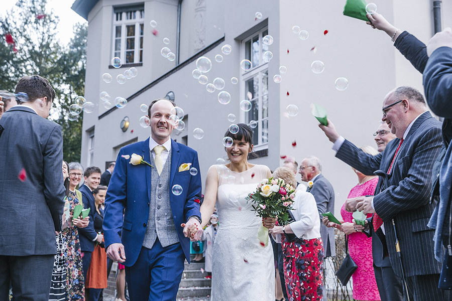Berlin Wannsee wedding photographer - Wedding party blow soap bubbles on newlyweds