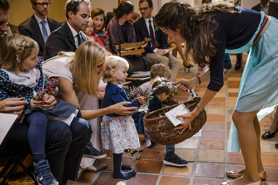 Toddler putting flowers in basket