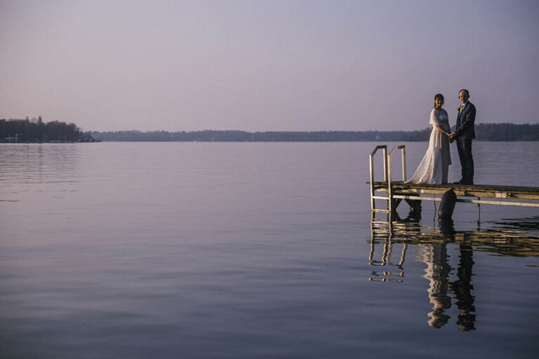 Newlyweds portrait on lake jetty