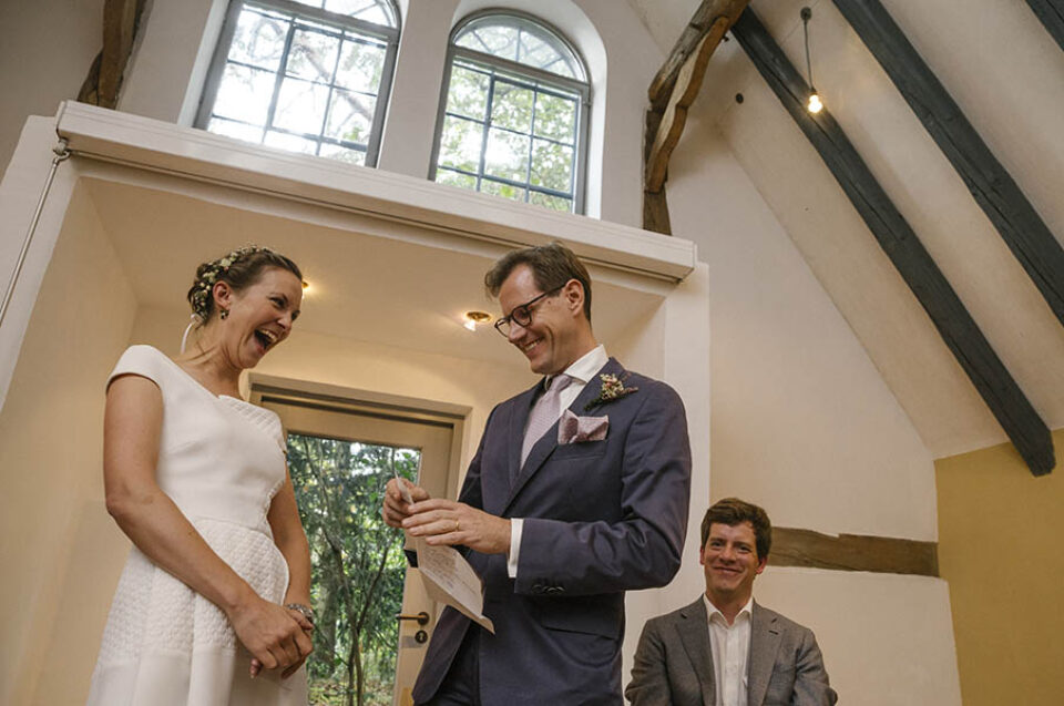 Bride and groom laughing in chapel