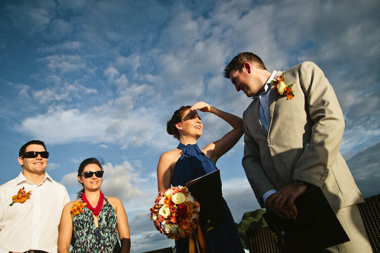 Bride looking at groom in sunlight