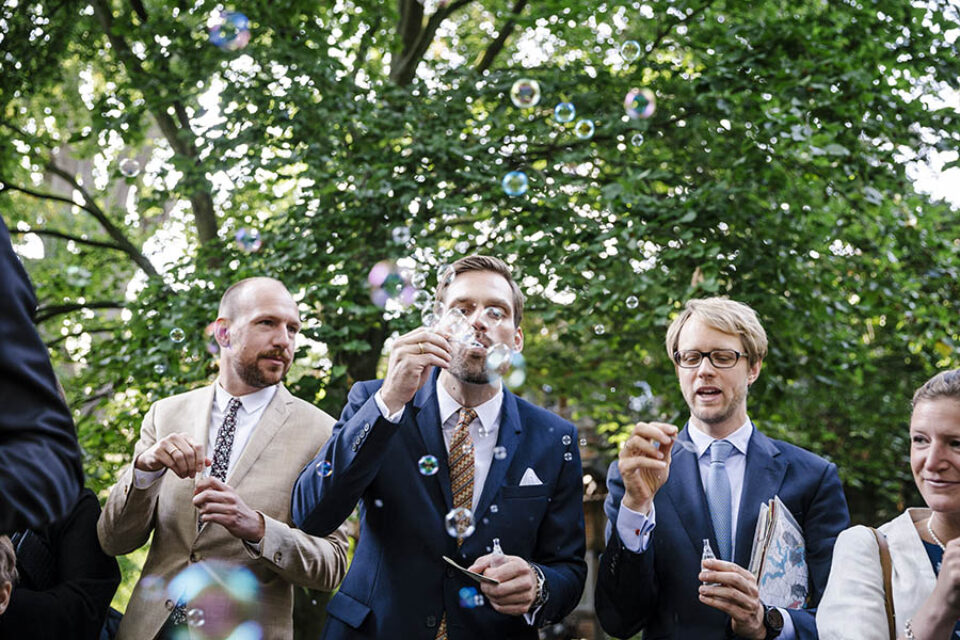 Wedding guest blowing soap bubbles