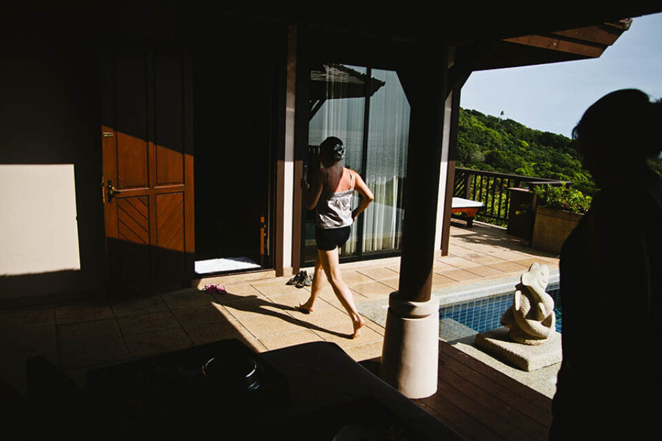 Bride running through sunlight