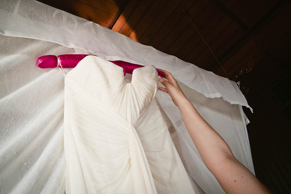 Hand reaching for wedding dress