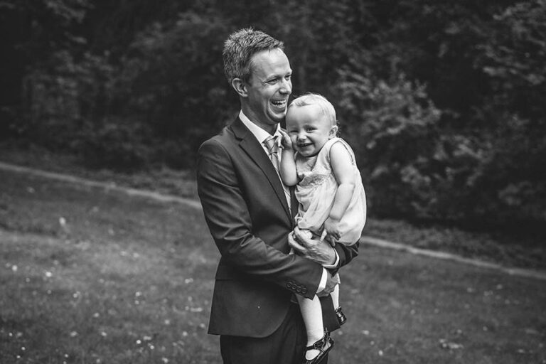 Father and daughter laughing in park