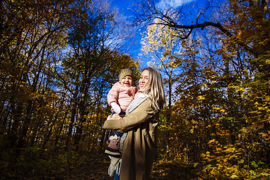 Mother and child in autumn leaves