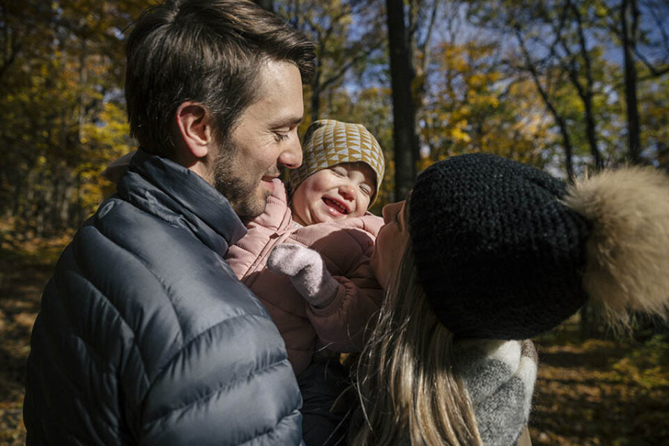 Toddler laughing with parents