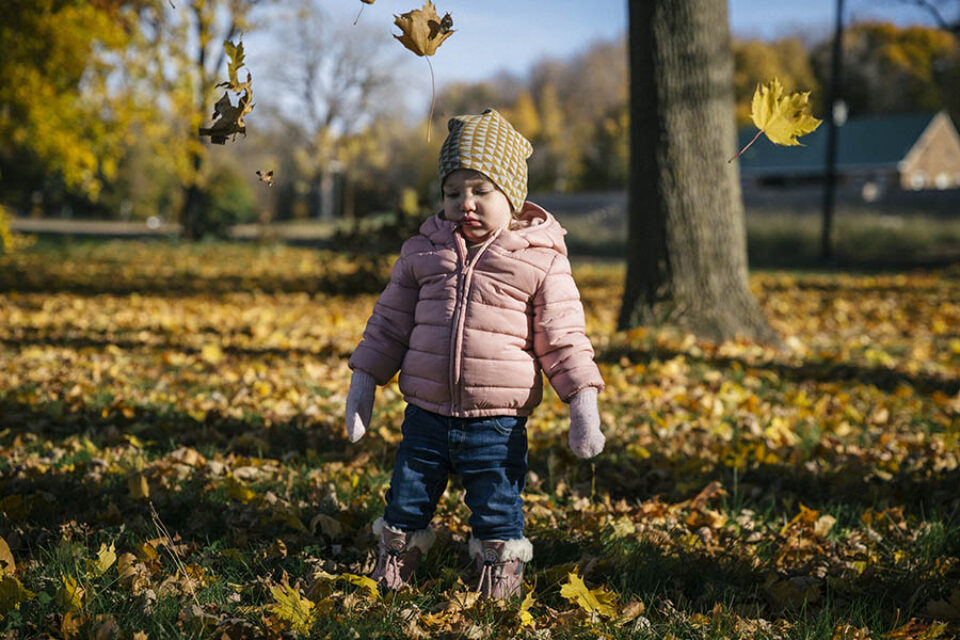 Toddler and falling leaves
