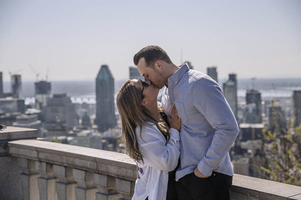 Newly engaged couple share kiss